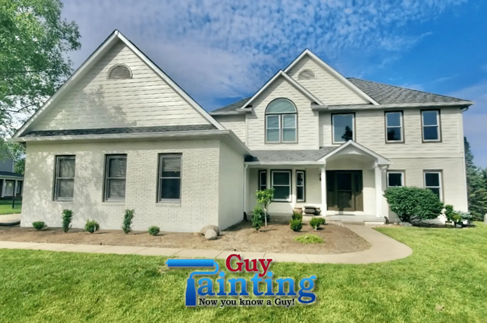 Carmel, Indiana home exterior repainted from tan brick to crisp Summer White by Guy Painting